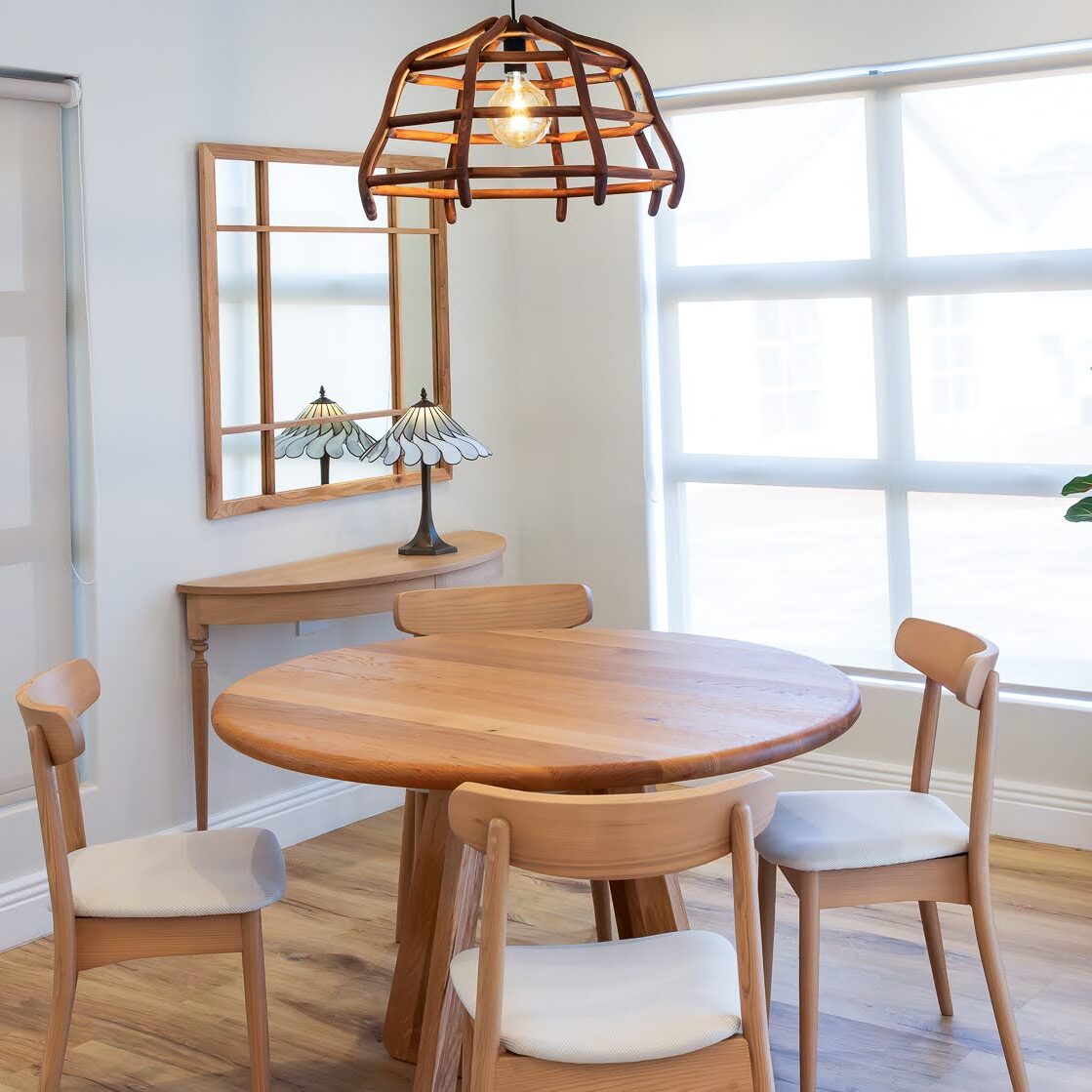 Ballito interior design dining area with custom solid oak table, dining chairs and bespoke wooden pendant.